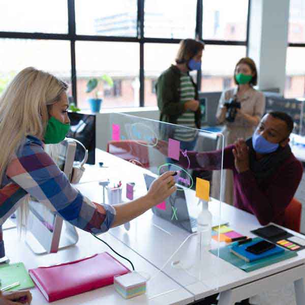 People Working In An Office Wearing Cloth Face Covers